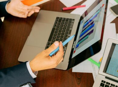 Free A Person in Black Suit Holding a Pen Stock Photo
